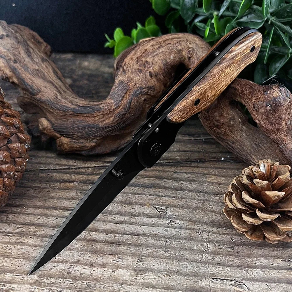 Folding blade with wooden handle on a range wooden surface with natural elements